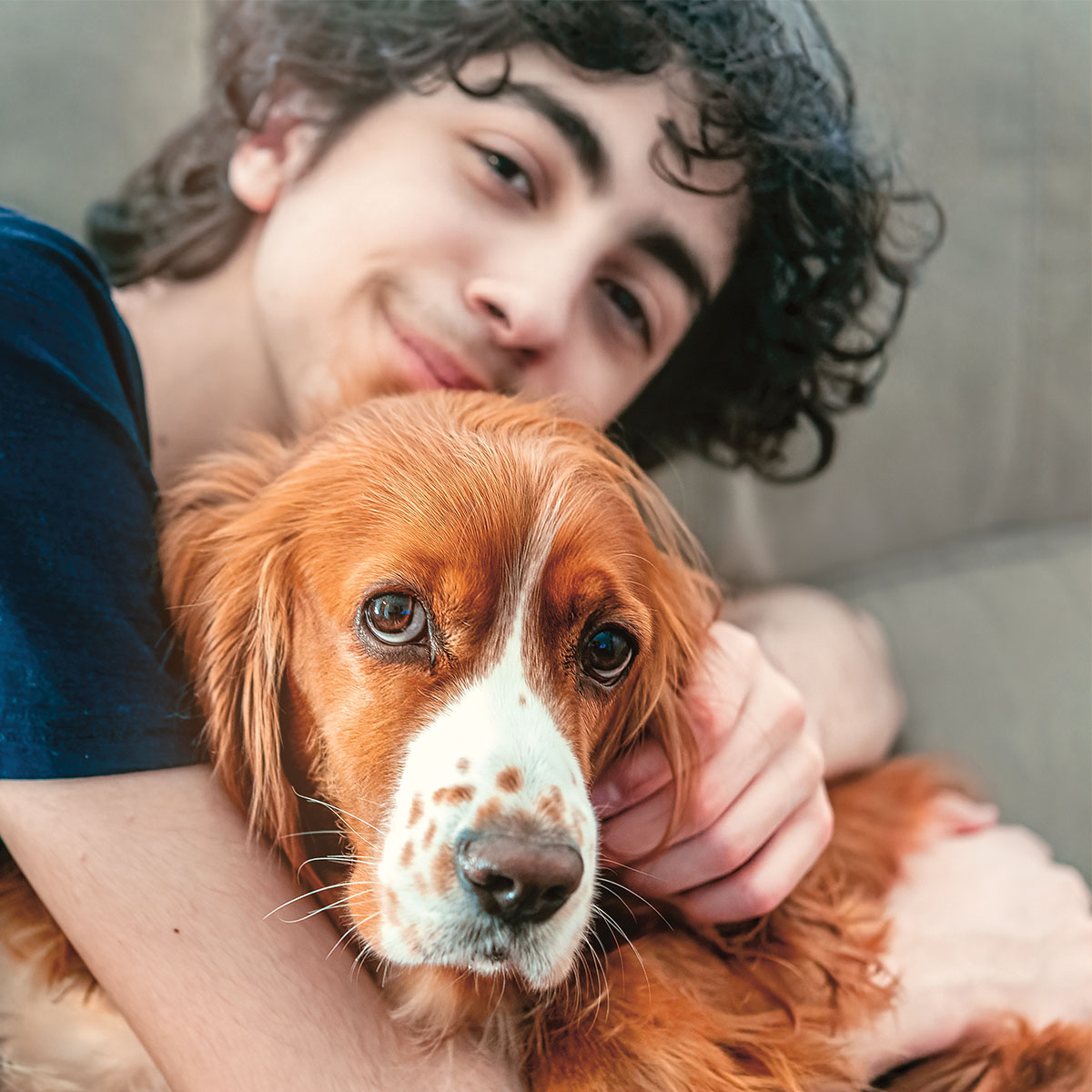 Photo of teen cuddling their dog